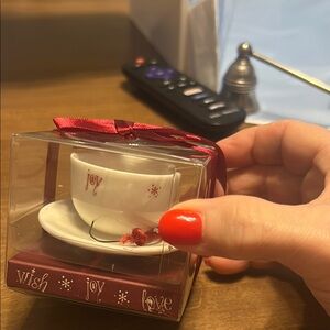 Festive Teacup and Saucer Set with Red Accents